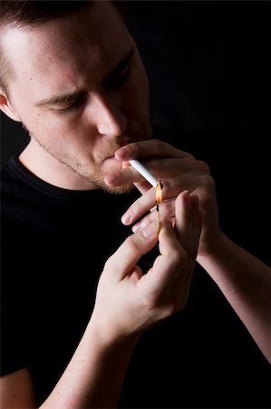 simsearch:400-04631926,k - man smoking a cigarette against black background Stock Photo - Budget Royalty-Free & Subscription, Code: 400-04057741