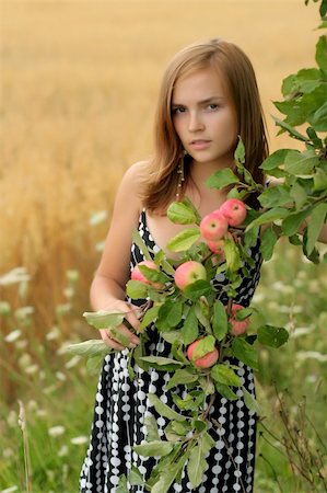 Girl with apples and mellow rye field behind Stock Photo - Budget Royalty-Free & Subscription, Code: 400-04058412