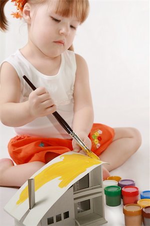 simsearch:400-05185635,k - Home Improvement - Little Girl repairs. Child colors by paint the mock-up of the house Photographie de stock - Aubaine LD & Abonnement, Code: 400-04059028