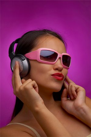 glamour portrait of young brunette in pink sunglasses listening music Stock Photo - Budget Royalty-Free & Subscription, Code: 400-04059231