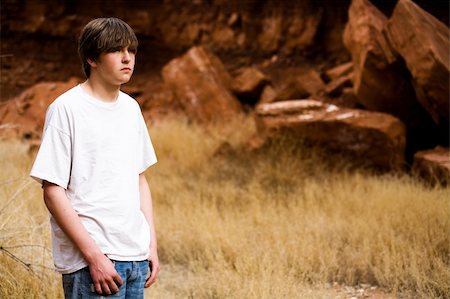 seventeen - teen boy in Wyoming wilderness area, large red-brown boulders in background, copyspace Stock Photo - Budget Royalty-Free & Subscription, Code: 400-04059435