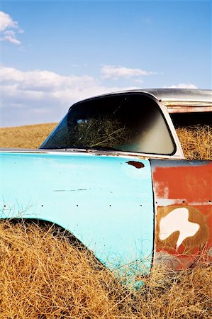 dry corrosion - vintage car in late sun, abandoned in a field slowly being consumed by nature Stock Photo - Budget Royalty-Free & Subscription, Code: 400-04059766