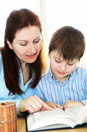 students working at library table - Teacher or tutor helping school boy to study Stock Photo - Budget Royalty-Free & Subscription, Code: 400-04059955