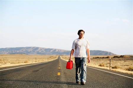 sascha (artist) - out of gas - teenager male walking down rural highway with empty red gas can Fotografie stock - Microstock e Abbonamento, Codice: 400-04059993