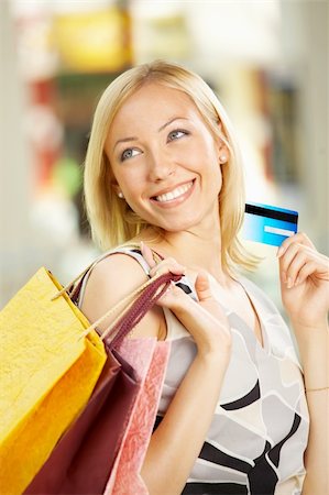 simsearch:400-04107785,k - The beautiful girl with purchases and a credit card Fotografie stock - Microstock e Abbonamento, Codice: 400-04050134