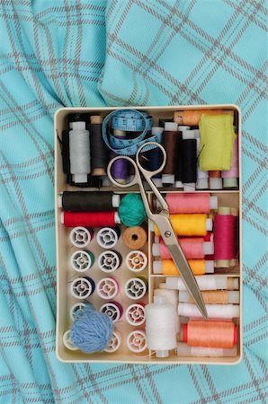 Spools, scissors, balls and measuring tape in the box on the piece of check fabric Stock Photo - Budget Royalty-Free & Subscription, Code: 400-04050223