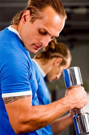 pic of dumbbell tattoo - Strong man in health club curling a dumbbell Stock Photo - Budget Royalty-Free & Subscription, Code: 400-04050477