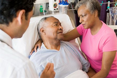 Senior Couple Talking To Doctor,Looking Worried Stock Photo - Budget Royalty-Free & Subscription, Code: 400-04050929