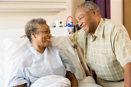Senior Couple Smiling At Each Other In Hospital Stock Photo - Budget Royalty-Free & Subscription, Code: 400-04050949