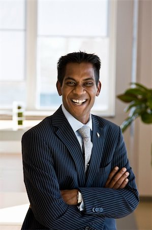 surpasspro (artist) - Indian Business Man Laughing with Arms Folded Indoors Foto de stock - Super Valor sin royalties y Suscripción, Código: 400-04051562