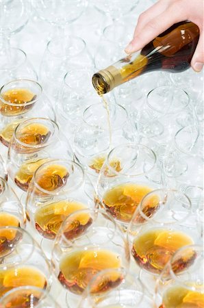 pour of liquor - poring the brandy into many glasses, selective focus Photographie de stock - Aubaine LD & Abonnement, Code: 400-04052006