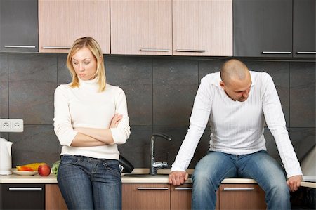 sad and quiet woman - The image of quarrel of a married couple on kitchen Stock Photo - Budget Royalty-Free & Subscription, Code: 400-04052452