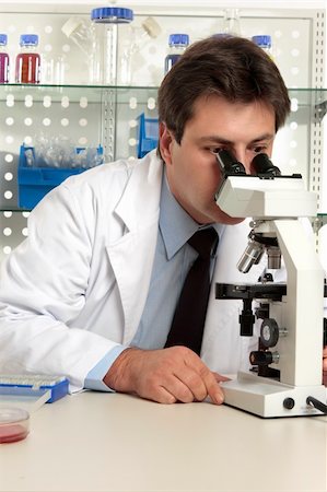 simsearch:400-05670478,k - Scientist, biologist, geneticist,  researcher  or healthcare worker studying an object under the microscope Stock Photo - Budget Royalty-Free & Subscription, Code: 400-04052592