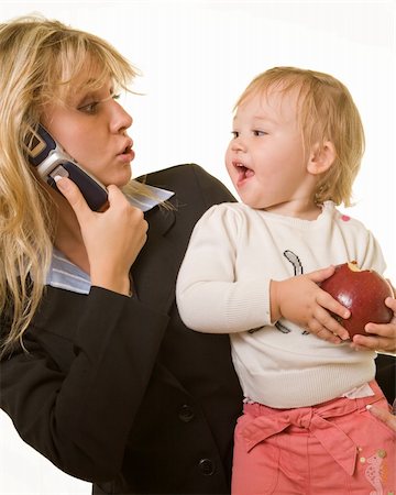 photos kids eating daycare - Attractive blond woman in business attire talking on cell phone carrying a cute baby girl with an apple looking at each other with cute expression Stock Photo - Budget Royalty-Free & Subscription, Code: 400-04052968