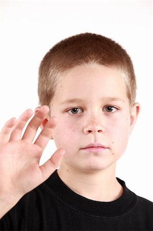 Young boy is preparing to say good bye. On white background Stock Photo - Budget Royalty-Free & Subscription, Code: 400-04053799