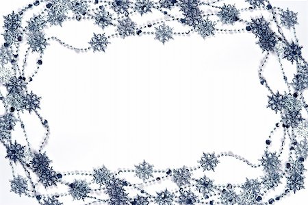 simsearch:400-04146770,k - Christmas frame made of silver snowflakes garland on white. Fotografie stock - Microstock e Abbonamento, Codice: 400-04053877