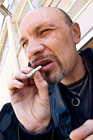 smoking and angry - street crime typical representative with cigarette in hand Stock Photo - Budget Royalty-Free & Subscription, Code: 400-04064525