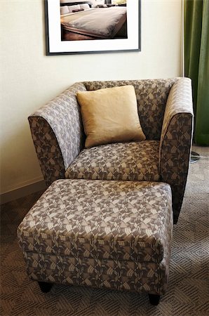 simsearch:700-00864697,k - Comfortable armchair with cushion and ottoman. Photo on the wall is my own. Stock Photo - Budget Royalty-Free & Subscription, Code: 400-04064741