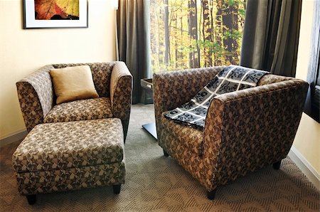 simsearch:700-00864697,k - Comfortable armchairs with cushion and ottoman. Photo on the wall is my own. Stock Photo - Budget Royalty-Free & Subscription, Code: 400-04064742