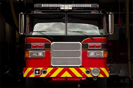 first responder - Red and yellow fire engine in garage bay in New England fires station. Stock Photo - Budget Royalty-Free & Subscription, Code: 400-04064979