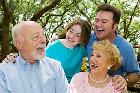 family and discussion and parent and teen and group not sad - Family in the park, laughing at a joke told by the grandfather. Stock Photo - Budget Royalty-Free & Subscription, Code: 400-04065015