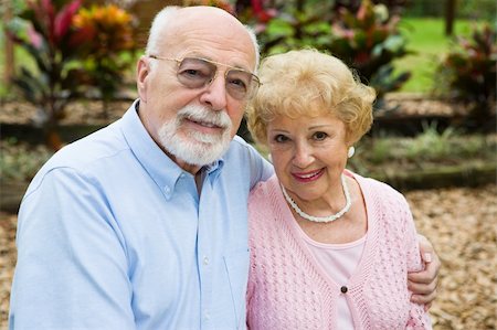 simsearch:400-04109826,k - Beautiful senior couple together in their garden.  Focus on her. Fotografie stock - Microstock e Abbonamento, Codice: 400-04065020