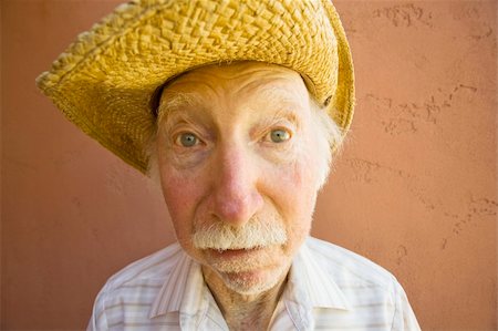 Senior Citizen Man with a Funny Expression Wearing a Straw Cowboy Hat Stock Photo - Budget Royalty-Free & Subscription, Code: 400-04065049