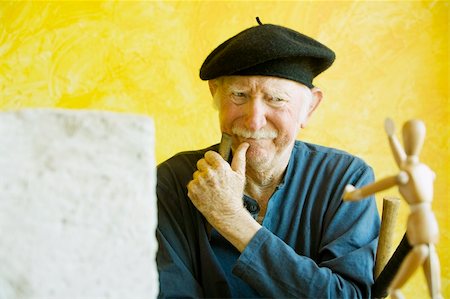 sculptor chisel man - Artist ponders a wooden figure model Stock Photo - Budget Royalty-Free & Subscription, Code: 400-04065367