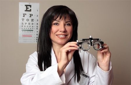 simsearch:400-07630065,k - An eye doctor holding a pair of eye test trial  frames Foto de stock - Super Valor sin royalties y Suscripción, Código: 400-04065651