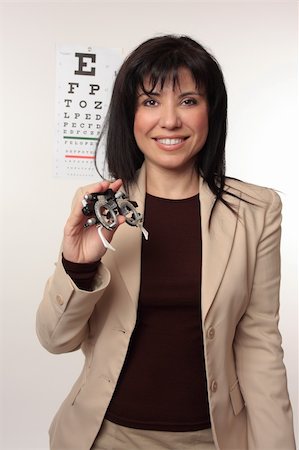 simsearch:400-07630065,k - Optician with a friendly smile holding a pair of trail frames Foto de stock - Super Valor sin royalties y Suscripción, Código: 400-04065653