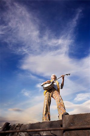 simsearch:400-05080507,k - Banjo Player with groovy clothes against a wide sky Stock Photo - Budget Royalty-Free & Subscription, Code: 400-04066379