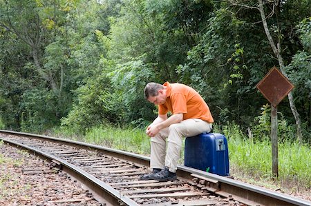 suitcase railway track - Man sitting on suitcase on railroad tracks Stock Photo - Budget Royalty-Free & Subscription, Code: 400-04066393