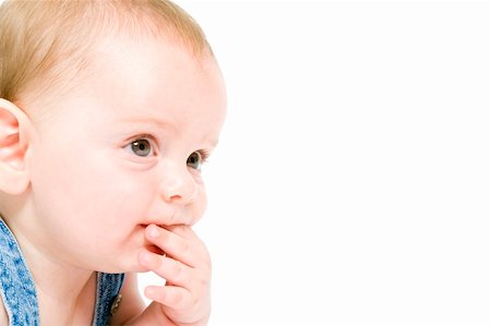 close-up of a six month old baby wearing jeans overall isolated on white Stock Photo - Budget Royalty-Free & Subscription, Code: 400-04066883