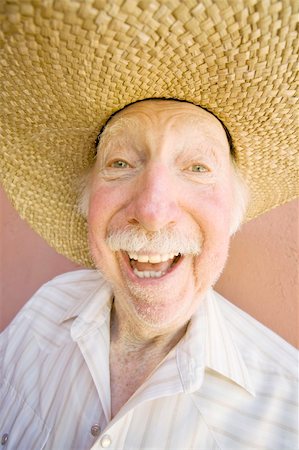 Senior Citizen Man with a Funny Expression Wearing a Straw Cowboy Hat Stock Photo - Budget Royalty-Free & Subscription, Code: 400-04067305