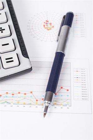 simsearch:400-04711612,k - Calculator and pen on earnings chart background. Shallow depth of field Stock Photo - Budget Royalty-Free & Subscription, Code: 400-04067553
