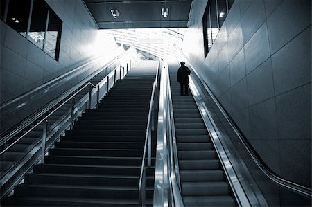 simsearch:700-07067164,k - Single female moving against the light in escalator - Berlin Central Station. - Duotone. Fotografie stock - Microstock e Abbonamento, Codice: 400-04068217