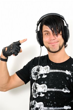 simsearch:400-04736573,k - Portrait of young trendy hispanic male pointing to headphones - isolated Photographie de stock - Aubaine LD & Abonnement, Code: 400-04068932