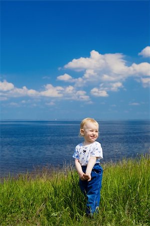 simsearch:400-04596901,k - small girl in green grass over the blue sky near the river Stock Photo - Budget Royalty-Free & Subscription, Code: 400-04069365