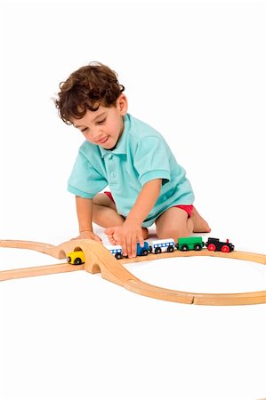 school rooms backgrounds - little boy playing with toy train isolated on white Stock Photo - Budget Royalty-Free & Subscription, Code: 400-04069387