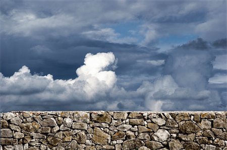 stone walls in meadows - Stone wall with a great cloudy sky in the beackground Stock Photo - Budget Royalty-Free & Subscription, Code: 400-04060069