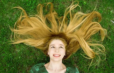 dundanim (artist) - Girl with beautiful blond hair laying in the grass Fotografie stock - Microstock e Abbonamento, Codice: 400-04060227