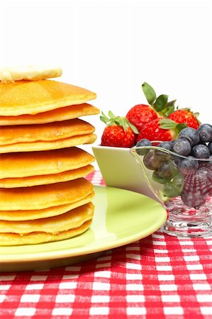 simsearch:400-06076486,k - A big stack of pancakes with butter, blueberries and strawberries on square background Foto de stock - Royalty-Free Super Valor e Assinatura, Número: 400-04061091