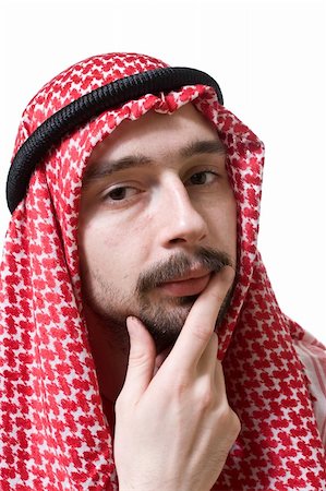 Portrait of an arabian young man in traditional headscarf - shemagh. He is thoughtful. Stock Photo - Budget Royalty-Free & Subscription, Code: 400-04061772