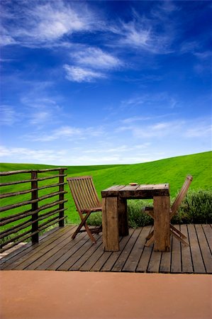Beautiful outdoor space with a table and chairs and in the beackground a beautiful green meadow Stock Photo - Budget Royalty-Free & Subscription, Code: 400-04062319