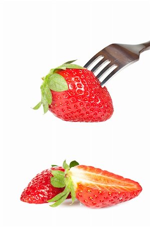 simsearch:400-04513818,k - The fork pricking the strawberry isolated on white background. Shallow depth of field Stock Photo - Budget Royalty-Free & Subscription, Code: 400-04062350