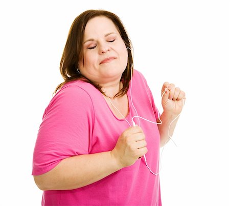 Pretty plus-sized model dancing to the music from her mp3 player.  Isolated on white. Stock Photo - Budget Royalty-Free & Subscription, Code: 400-04062387