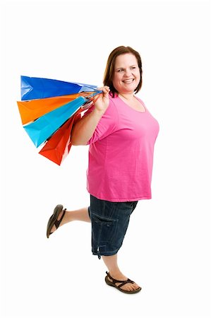 Beautiful plus-sized model enjoys shopping.  Full body isolated on white. Stock Photo - Budget Royalty-Free & Subscription, Code: 400-04062388