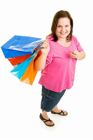 Pretty plus-sized woman shopping and listening to music on her mp3 player.  Full body isolated on white. Foto de stock - Super Valor sin royalties y Suscripción, Código: 400-04062397