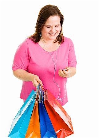 Pretty plus-sized woman holding her shopping bags and listening to music.  Isolated on white. Foto de stock - Super Valor sin royalties y Suscripción, Código: 400-04062393