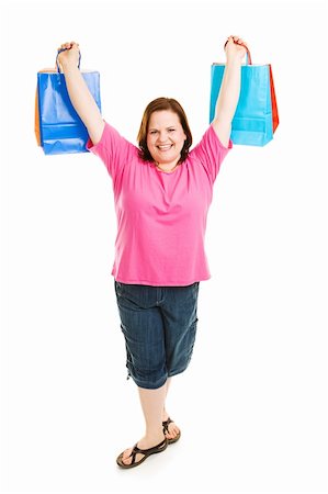 Beautiful plus-sized model holding up her shopping bags.  Full body isolated on white. Foto de stock - Super Valor sin royalties y Suscripción, Código: 400-04062401